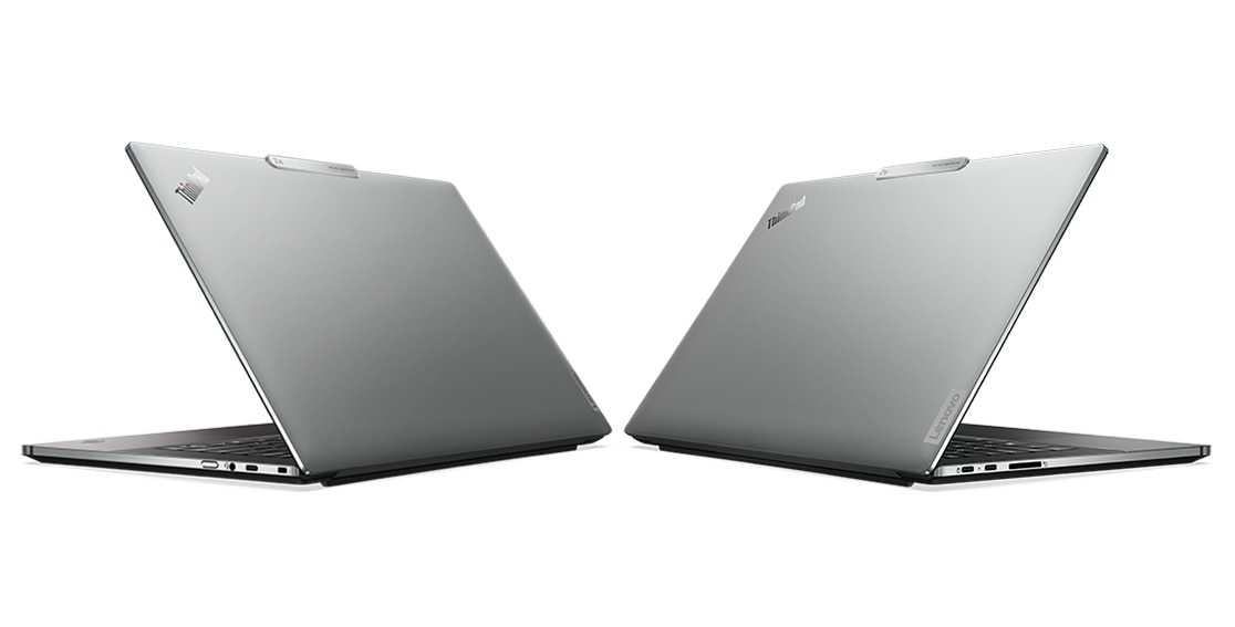 Two Lenovo ThinkPad Z16 laptops, back-to-back, angled to show recycled aluminum covers and ports on both sides. 