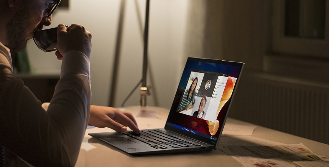 Person at a table videoconferencing on the Lenovo ThinkPad X1 Carbon Gen 10 laptop. 
