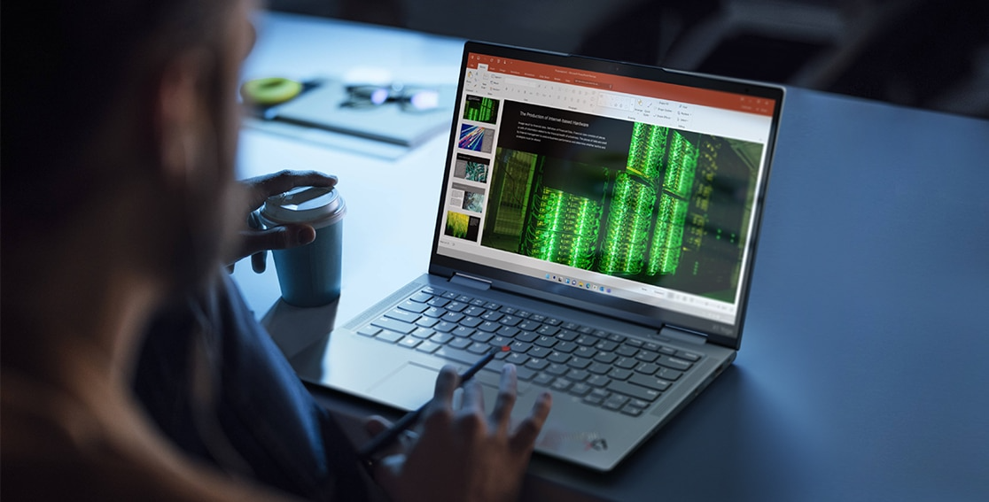 The Lenovo ThinkPad X1 Yoga Gen 7 2-in-1 open on a desk with hand holding the integrated pen.