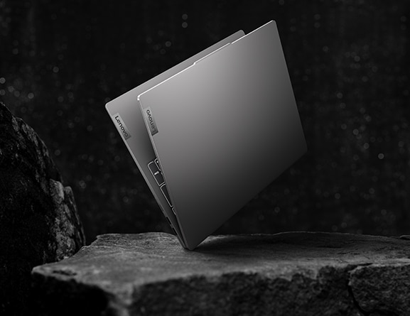 Rear-facing IdeaPad Slim 5 Gen 8 laptop with-standing spilled water around its base.