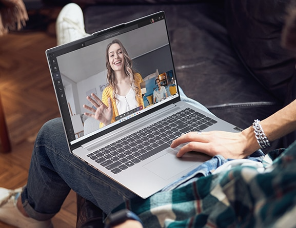 A user meeting in a video conference call on the IdeaPad Slim 5 Gen 8 laptop on his/her lap.