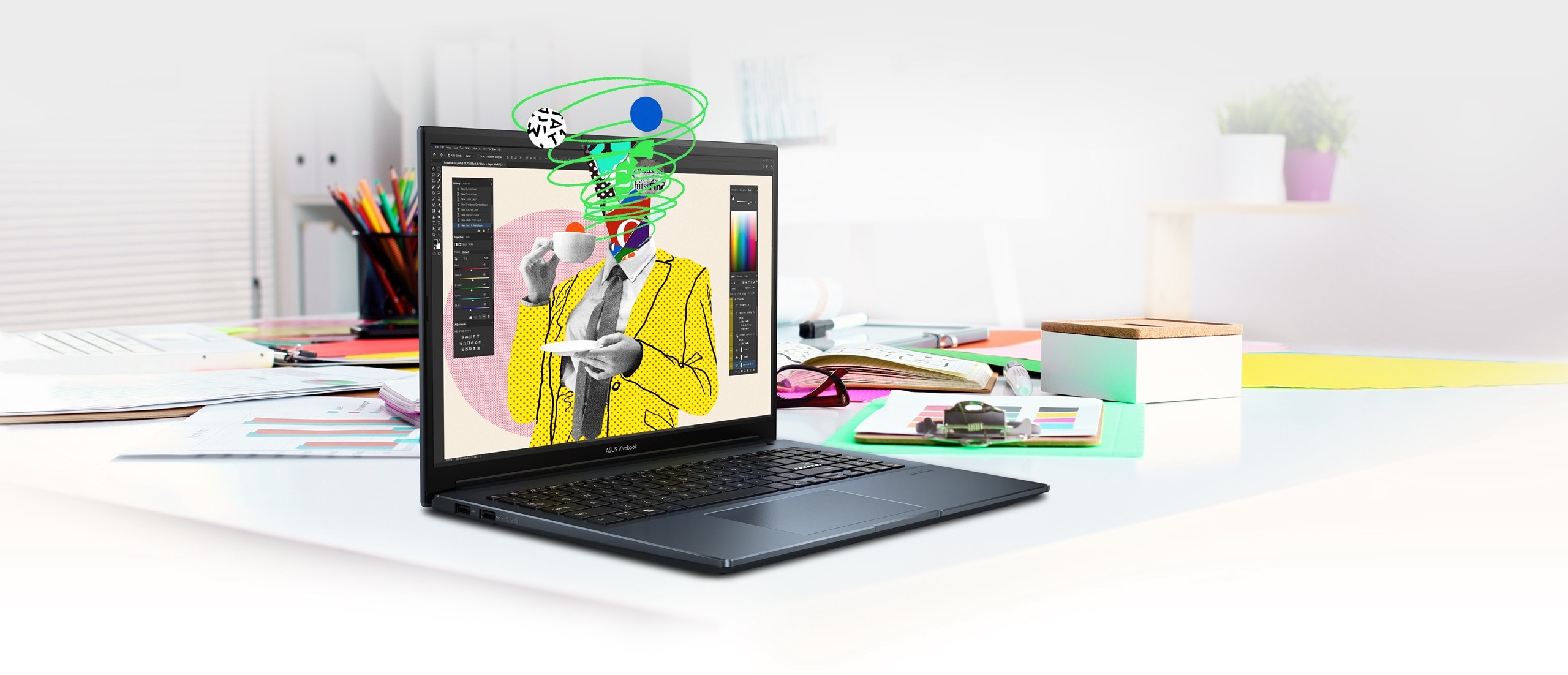 Vue avant gauche du Vivobook Pro 15 OLED sur une table avec du matériel d'artiste et de la papeterie. Un graphique de dessin animé coloré représentant un homme buvant une tasse de thé est affiché à l'écran.